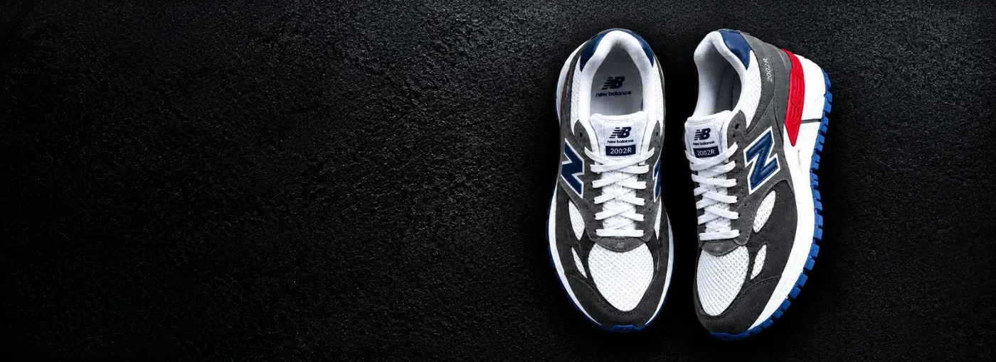 New Balance 2002R men's sneakers in grey, white, navy and red with blue sole, Baggiva Stores