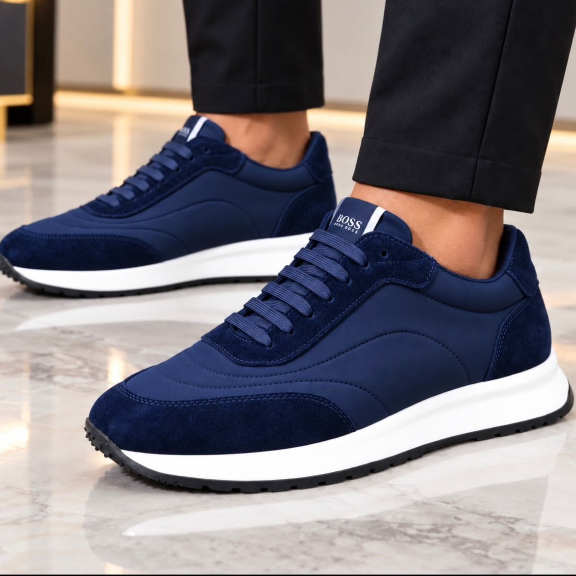 BOSS men's navy low-top sneakers worn with black trousers